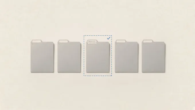 A row of five grey file folders; only one has a written label, and it sits inside a dashed boundary with a check mark